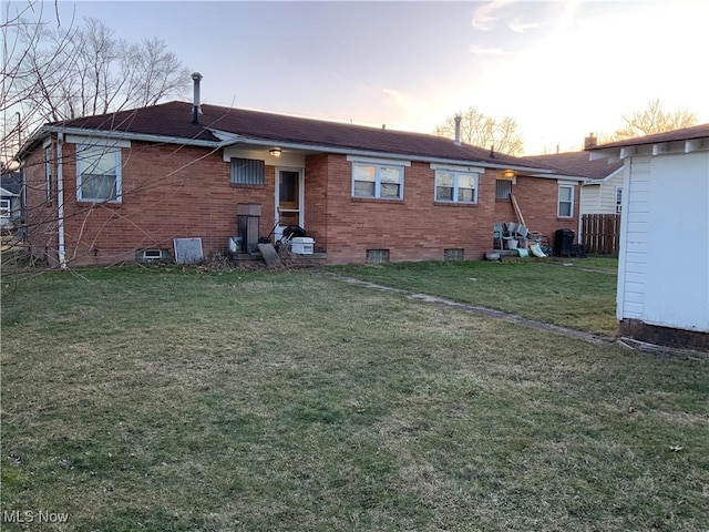 back house at dusk with a yard