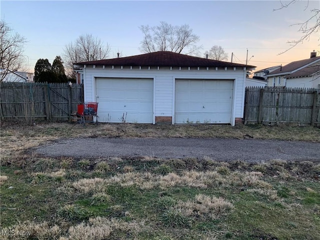 view of garage at dusk