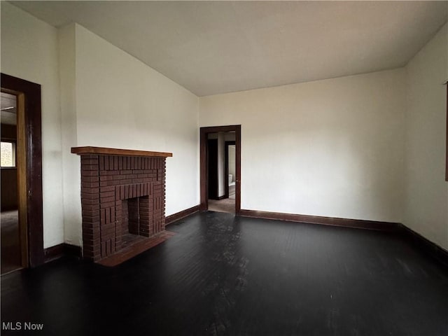 unfurnished living room with a brick fireplace