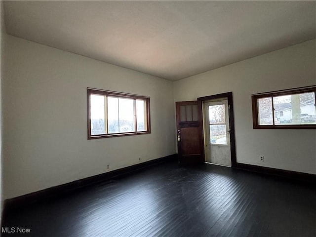 unfurnished room with dark hardwood / wood-style floors