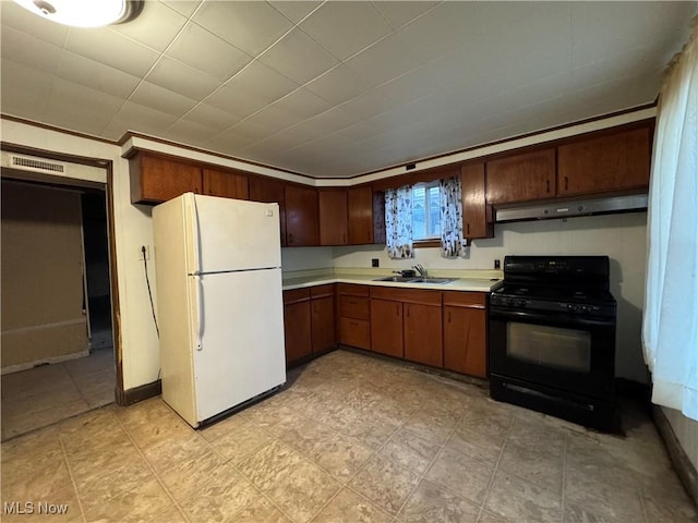 kitchen featuring sink, electric range, and white refrigerator