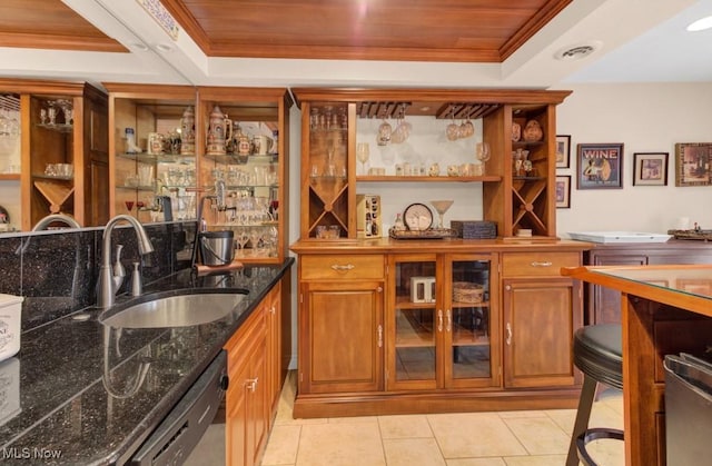 bar with black dishwasher, sink, wooden ceiling, and a tray ceiling