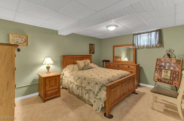 carpeted bedroom with a paneled ceiling