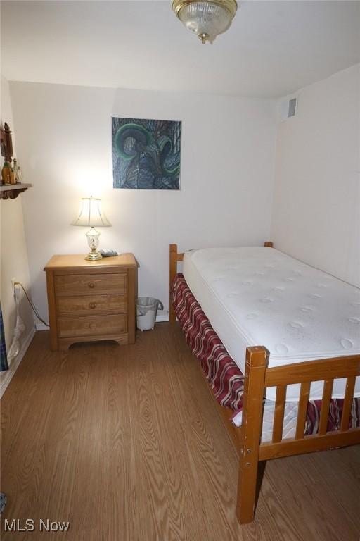 bedroom with hardwood / wood-style flooring