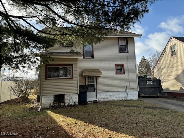 rear view of house with a yard