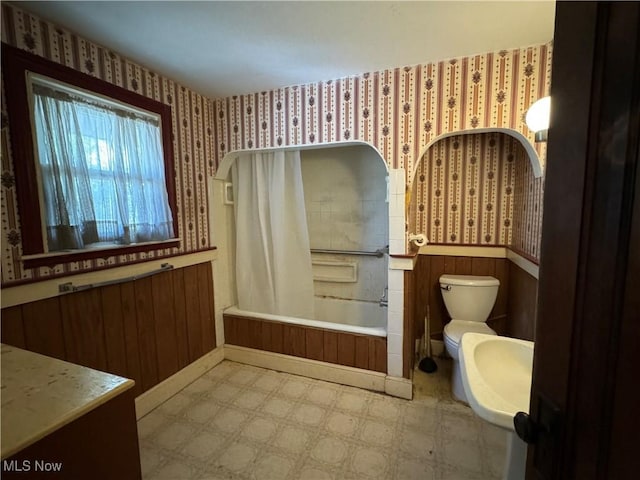 bathroom with shower / tub combo and toilet