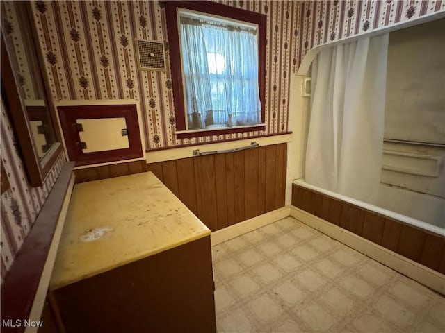 bathroom with wood walls