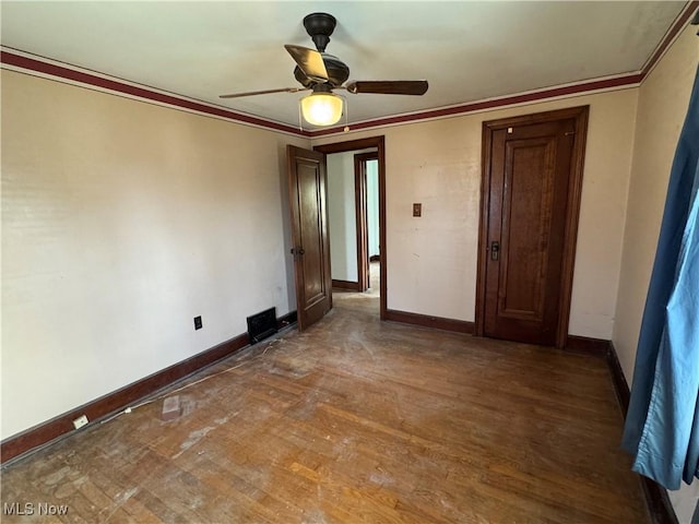 unfurnished room with ceiling fan, ornamental molding, and dark hardwood / wood-style floors