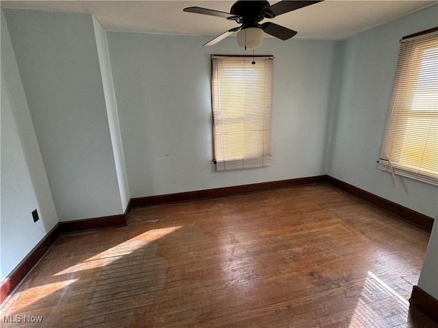 unfurnished room featuring ceiling fan and dark hardwood / wood-style flooring