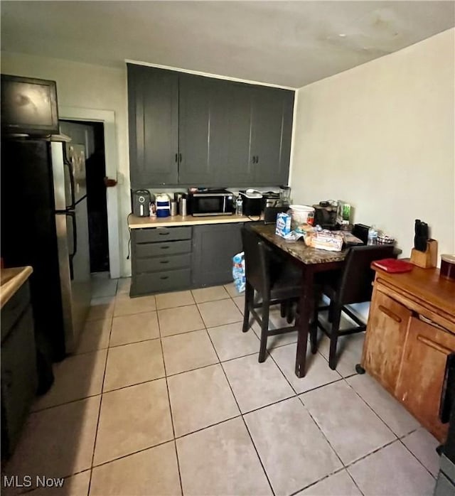 kitchen featuring appliances with stainless steel finishes and light tile patterned floors