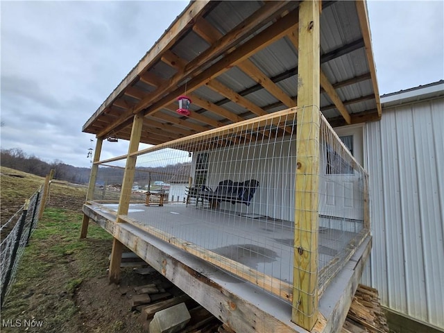 wooden terrace featuring an outdoor structure