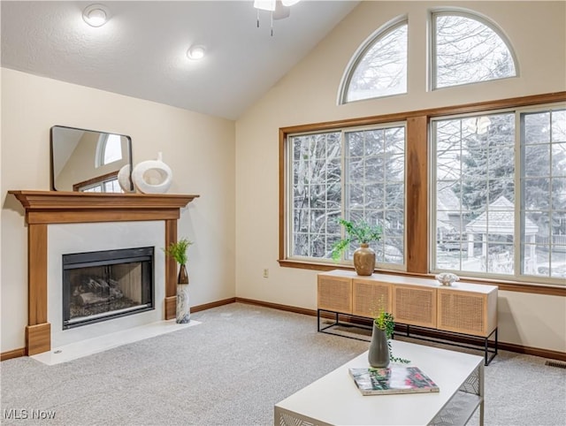 sitting room featuring ceiling fan, light colored carpet, and high vaulted ceiling