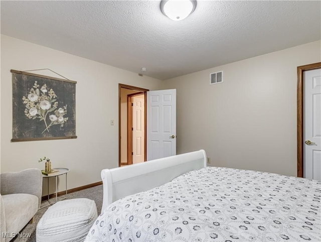 carpeted bedroom featuring a textured ceiling