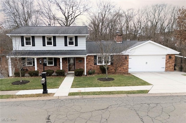 traditional-style house with a front lawn, concrete driveway, covered porch, and a chimney