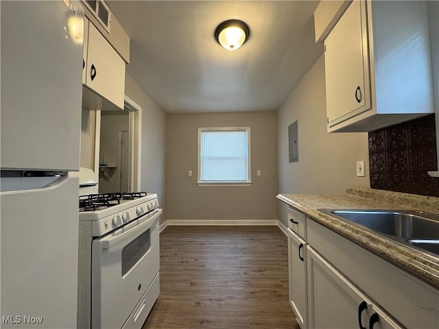 kitchen with white cabinetry, dark hardwood / wood-style floors, white gas range, and refrigerator