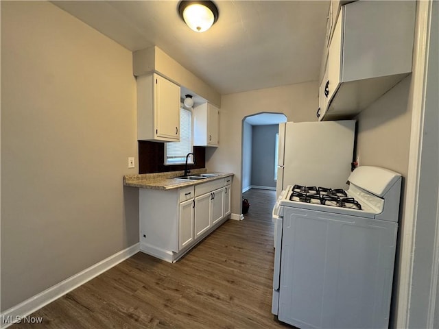 kitchen with white cabinetry, sink, white appliances, and dark wood-type flooring