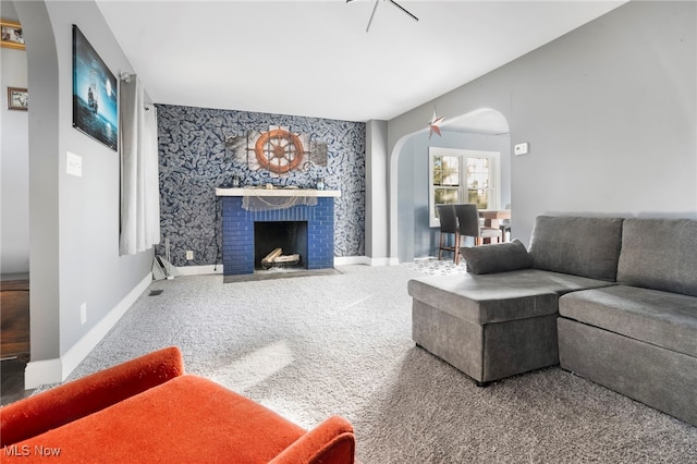 carpeted living room with a fireplace