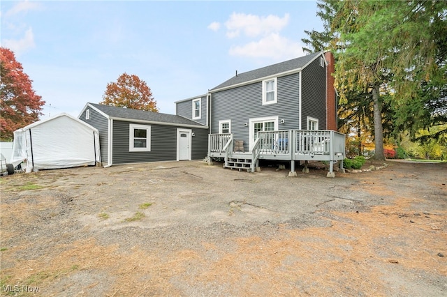 back of property featuring a deck