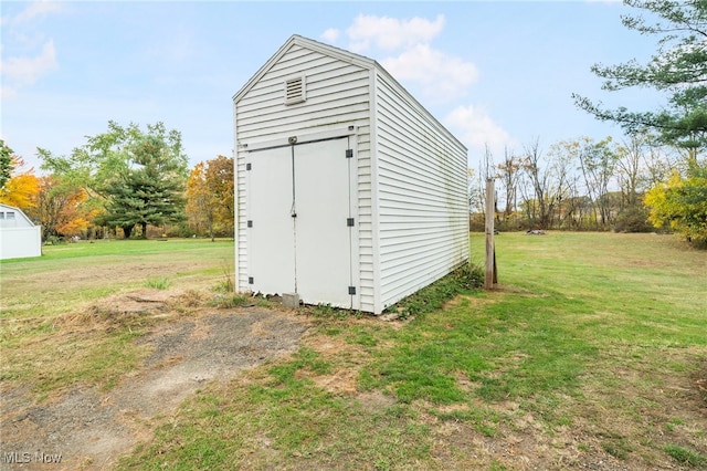 view of outbuilding featuring a lawn