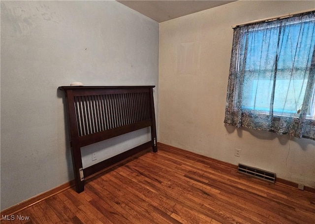 unfurnished bedroom with hardwood / wood-style flooring