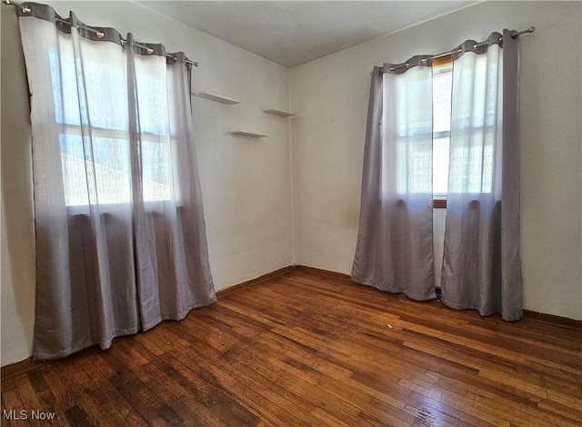 spare room featuring dark hardwood / wood-style flooring