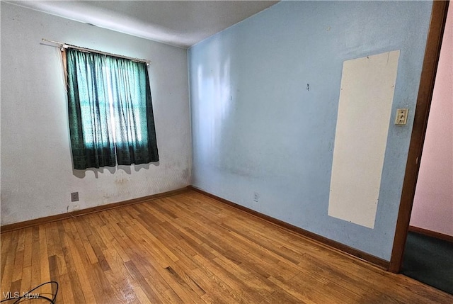 unfurnished room featuring wood-type flooring