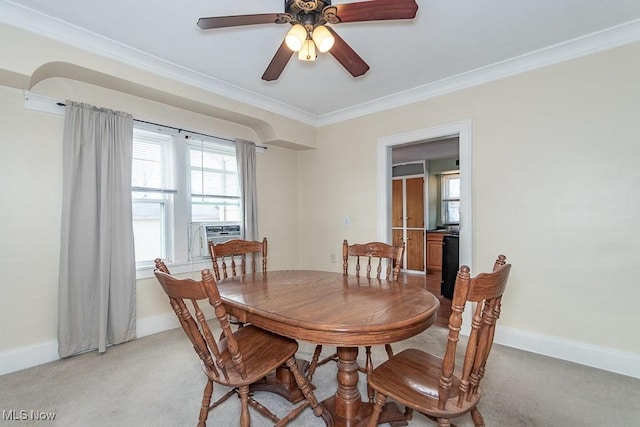 carpeted dining room featuring ornamental molding, cooling unit, and ceiling fan