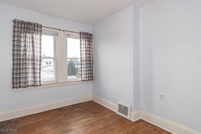 empty room featuring dark wood-type flooring