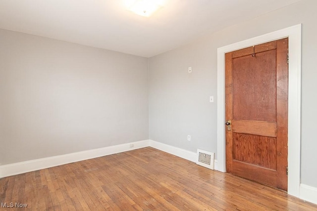 empty room featuring wood-type flooring