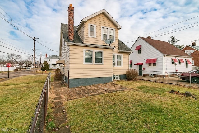 back of house with a lawn