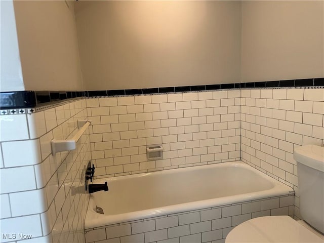 full bathroom with a garden tub and toilet