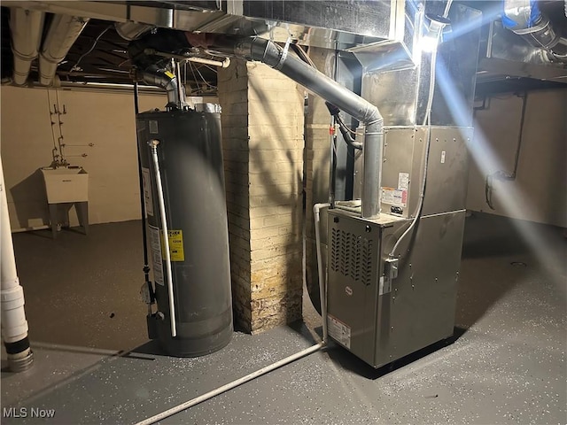 utility room with heating unit, water heater, and a sink