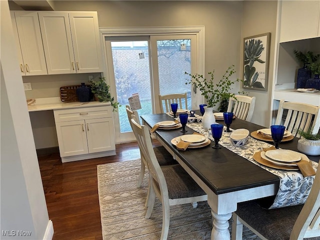 dining area featuring dark wood-style floors, plenty of natural light, and baseboards