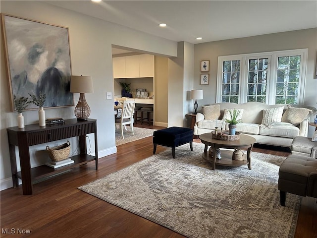 living area featuring recessed lighting, baseboards, and wood finished floors