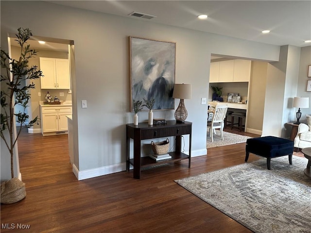 interior space featuring recessed lighting, dark wood-style flooring, visible vents, and baseboards