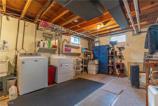 basement with a healthy amount of sunlight and washer and clothes dryer