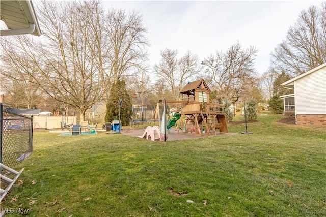 view of yard with a playground and a trampoline