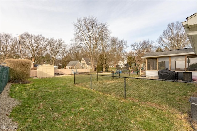 view of yard with a storage shed and a sunroom