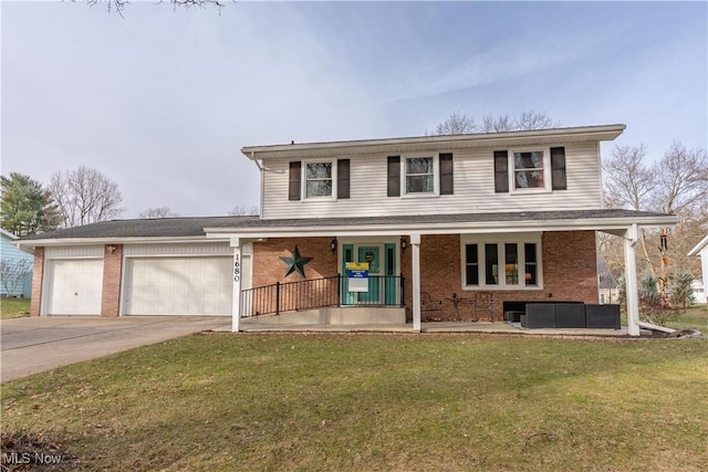 front facade featuring a garage, a front yard, and covered porch