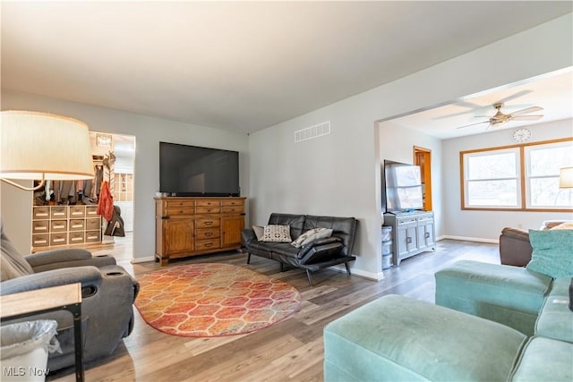 living room with hardwood / wood-style flooring and ceiling fan