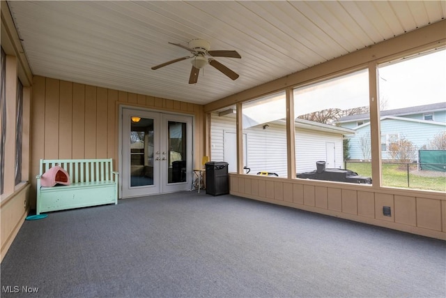 unfurnished sunroom featuring ceiling fan and french doors