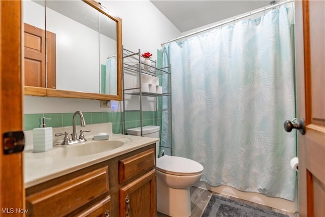 bathroom with vanity, toilet, hardwood / wood-style floors, and decorative backsplash