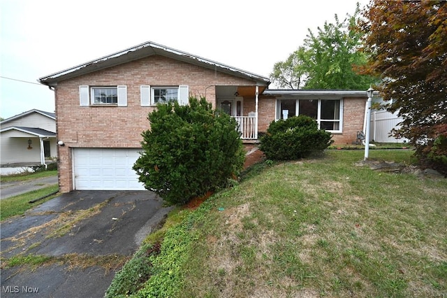 view of front of property with a garage and a front lawn