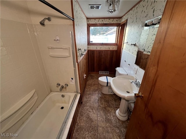 full bathroom featuring toilet, tiled shower / bath combo, and sink