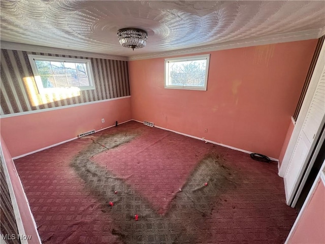 carpeted empty room featuring plenty of natural light