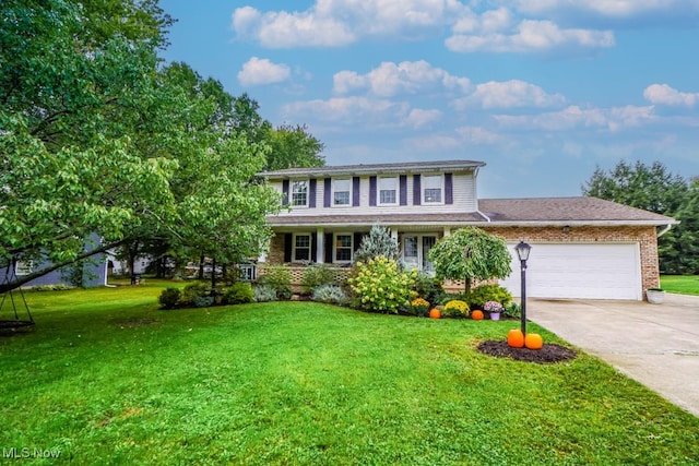 colonial-style house featuring a garage and a front lawn