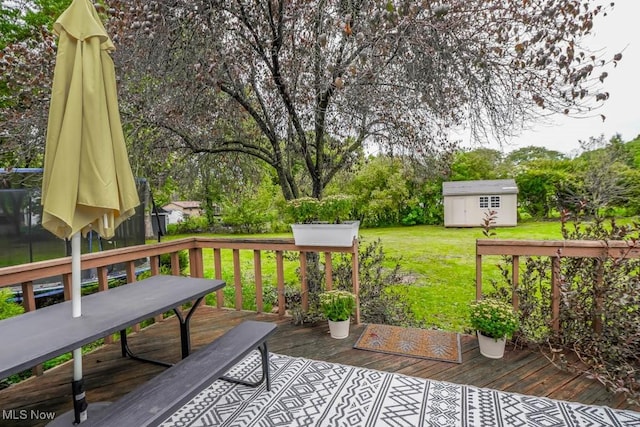 wooden deck featuring a storage shed and a yard