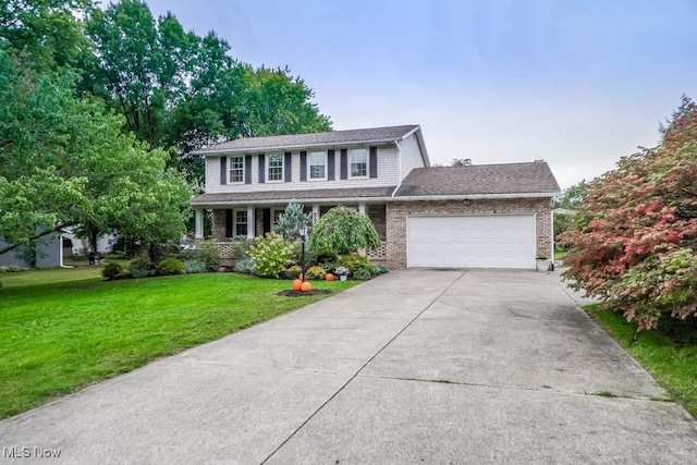 view of front of home featuring a garage and a front lawn