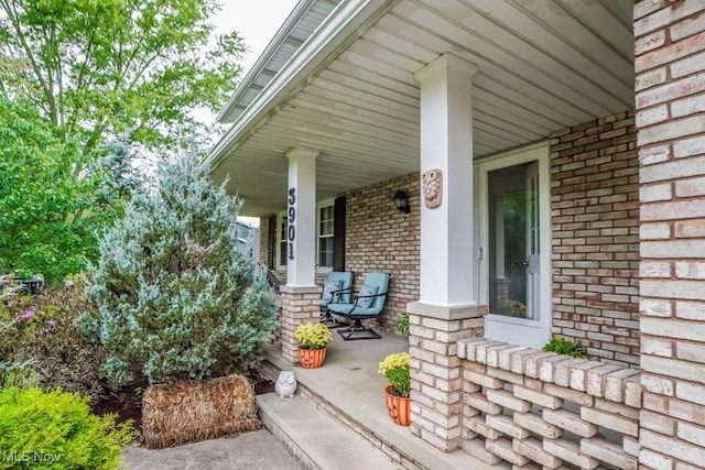 view of exterior entry featuring covered porch