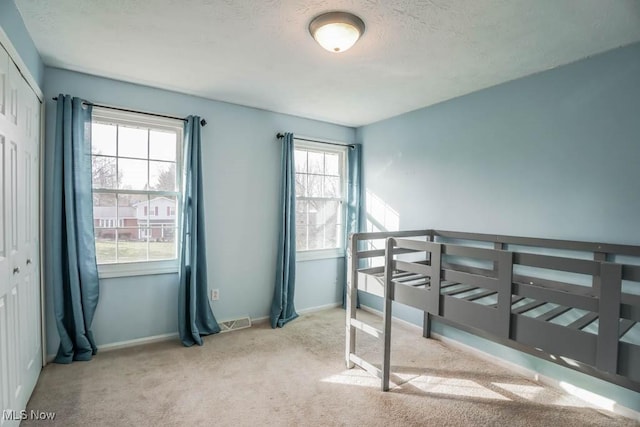 carpeted bedroom featuring a closet